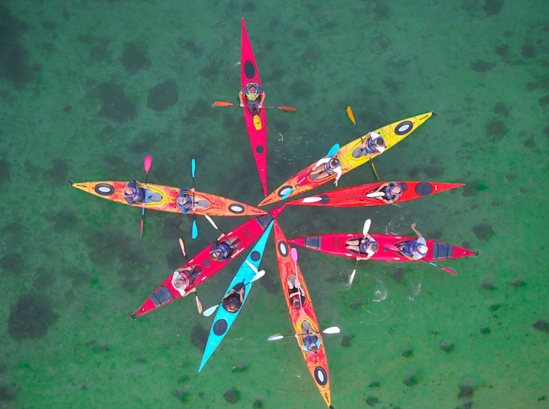 Group of kayaks on a lake in a circle