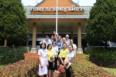 Group of educators and researchers standing outside hotel in Thailand