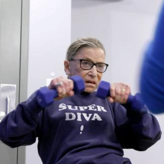 Elderly woman using hand weights.